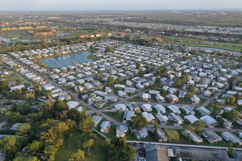 Aerial view of a large residential community near a lake