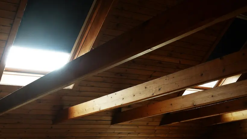 Wooden rafters and ceiling boards in an attic