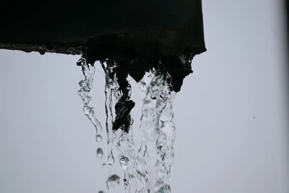 Water cascading from a metal gutter